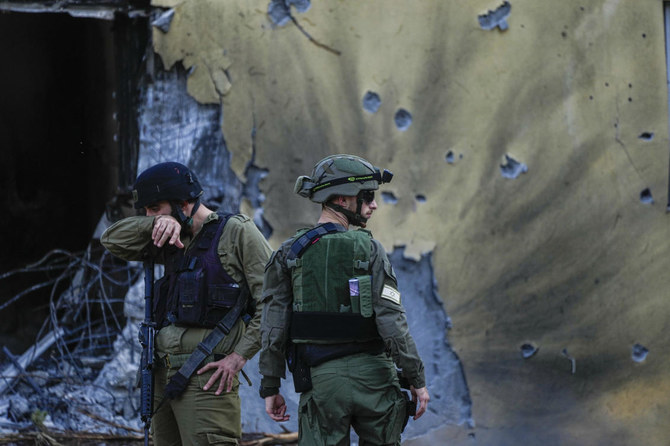Israeli soldiers walk past houses destroyed by Hamas militants in Kibbutz Be'eri, Israel, on Oct. 14, 2023. (AP/File)