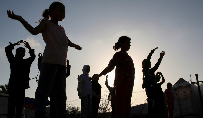 Girls train for boxing under Palestinian boxing coach Osama Ayoub near a tent camp sheltering displaced people, amid the Israel-Hamas conflict, in Khan Younis in the southern Gaza Strip, July 10, 2024. (REUTERS)
