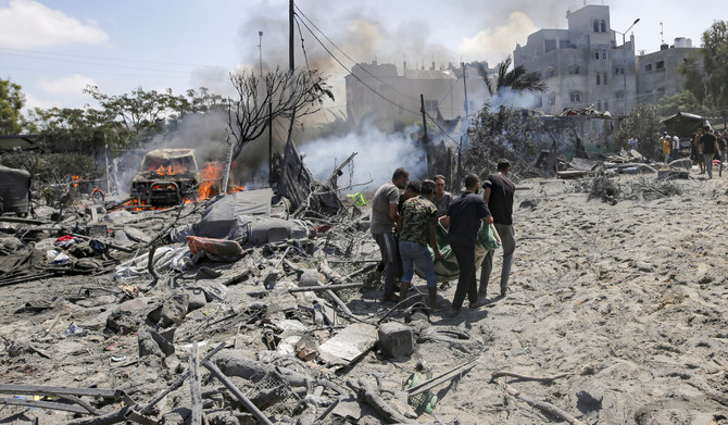 Palestinians evacuate a body from a site hit by an Israeli bombardment on Khan Younis, southern Gaza Strip, Saturday, July 13, 2024. (AP)