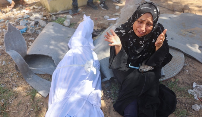A Palestinian woman mourns by the body of a relative killed in an Israeli strike which hit a makeshift prayer hall at al-Shati refugee camp west of Gaza City on July 13, 2024 amid the ongoing conflict between Israel and the militant Hamas group in Gaza. (AFP)