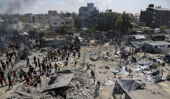 Palestinians inspect the damage at a site hit by an Israeli bombardment on Khan Younis, southern Gaza Strip, Saturday, July 13, 2024. (AP)