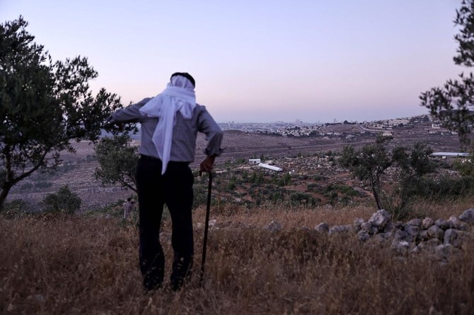 Olayan Olayan, who was born in the village of Battir in 1941, overlooks a valley in which a new Israeli settlers outpost is built, as pictured from Battir, a UNESCO heritage village in the occupied West Bank south of Jerusalem. (AFP)