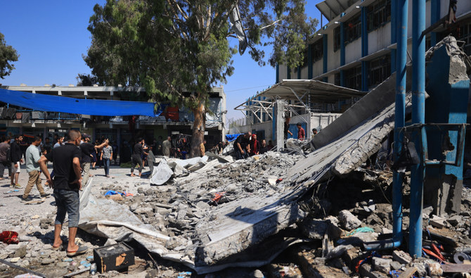 Palestinians check the destruction at the UN-run Al-Razi School in the Nuseirat refugee camp after an Israeli strike on July 16, 2024. (AFP)