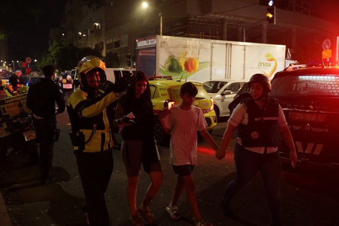 Emergency personnel assist people at the site of an explosion amid the Israel-Hamas conflict in Tel-Aviv, Israel. (Reuters)