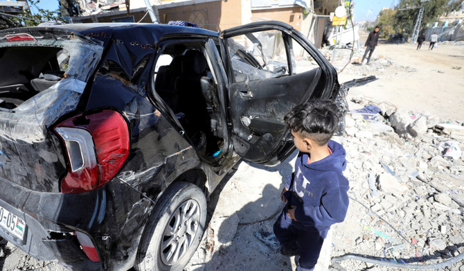 A child walks near a car where the body of Palestinian girl Hind Rajab, 6, who begged Gaza rescuers to send help after being trapped by Israeli military fire, was found along with the bodies of five of her family members in Gaza City, February 10, 2024. (REUTERS)