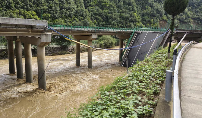 In this photo released by Xinhua News Agency, a collapsed bridge is seen in Zhashui County in Shangluo City, northwest China's Shaanxi Province, Saturday, July 20, 2024. (Xinhua via AP)