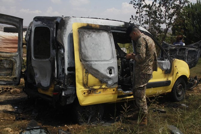 A Lebanese army soldier checks the wreckage of a vehicle after an Israeli air strike targeted the area near the village of Burj Al-Muluk, some 18km (11 miles) from the town of Nabatiyeh on July 20, 2024, amid ongoing cross-border clashes between Israeli troops and Lebanon’s Hezbollah fighters. (AFP)