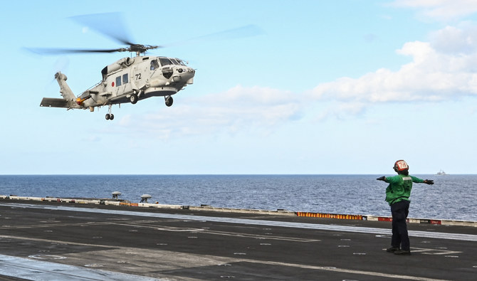 A Japan Maritime Self-Defense Force SH-60K helicopter lands on the deck of the USS Carl Vinson aircraft carrier during a three-day maritime exercise between the US and Japan in the Philippine Sea on January 31, 2024. (AFP/File)