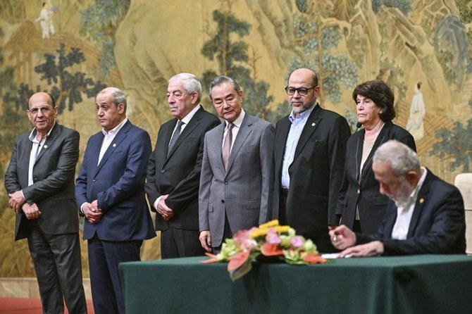 China’s Foreign Minister Wang Yi, fourth left, looks on, while hosting an event of signing of the “Beijing declaration” between Palestinian factions, Fatah and Hamas, at the Diaoyutai State Guesthouse in Beijing, on Jul. 23, 2024. (AP/File)