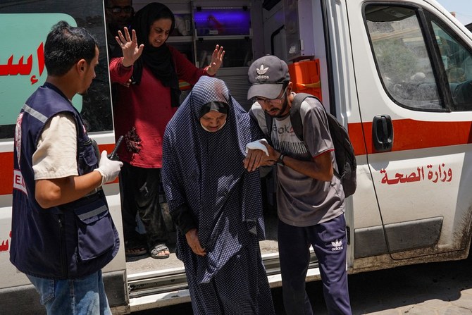 An injured woman is rushed to the al-Aqsa hospital, after a school where she had taken refuge was hit by an Israeli strike, in Deir el-Balah in the central Gaza Strip on July 27, 2024, amid the ongoing conflict between Israel and the Palestinian militant group Hamas (AFP)