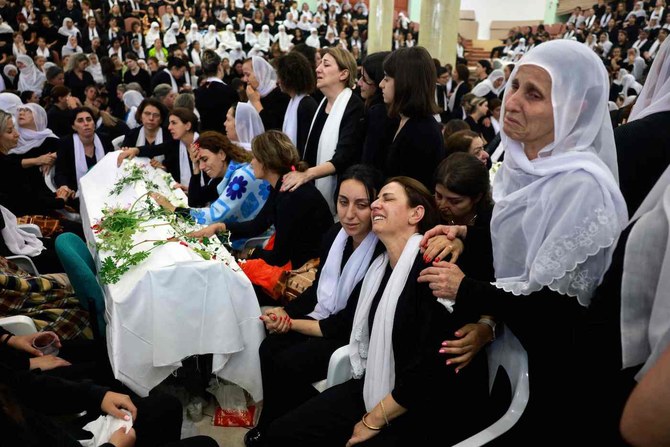 Druze women mourn by a coffin during a funeral of a person killed in a rocket strike from Lebanon a day earlier in the Israel-annexed Golan Heights. (AFP)