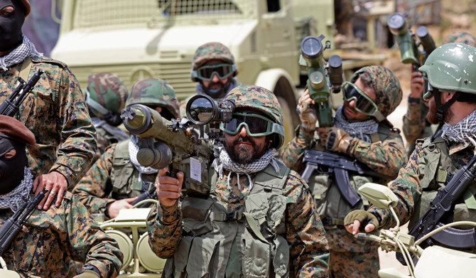 Lebanese Hezbollah fighters take part in cross-border raids, part of large-scale military exercise, in Aaramta bordering Israel on May 21, 2023 ahead of the anniversary of Israel's withdrawal from southern Lebanon in 2000. (AFP)