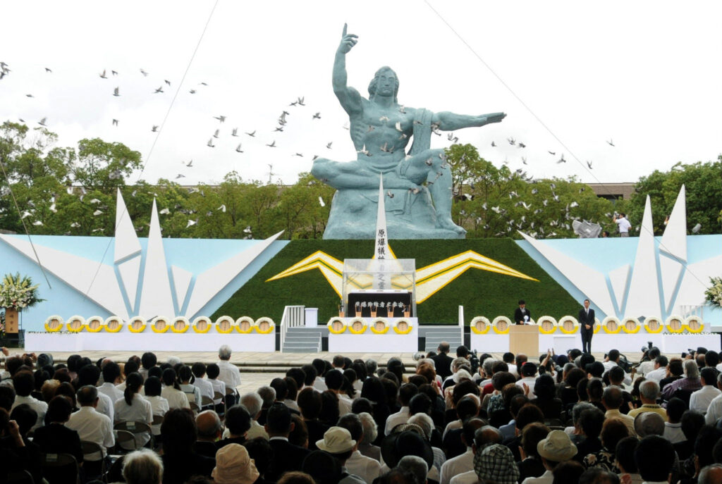 Doves fly around the Peace Statue of the Peace Memorial Park after being released in the Memorial Ceremony for atomic bomb victims in Nagasaki, western Japan on August 9, 2010. (AFP)