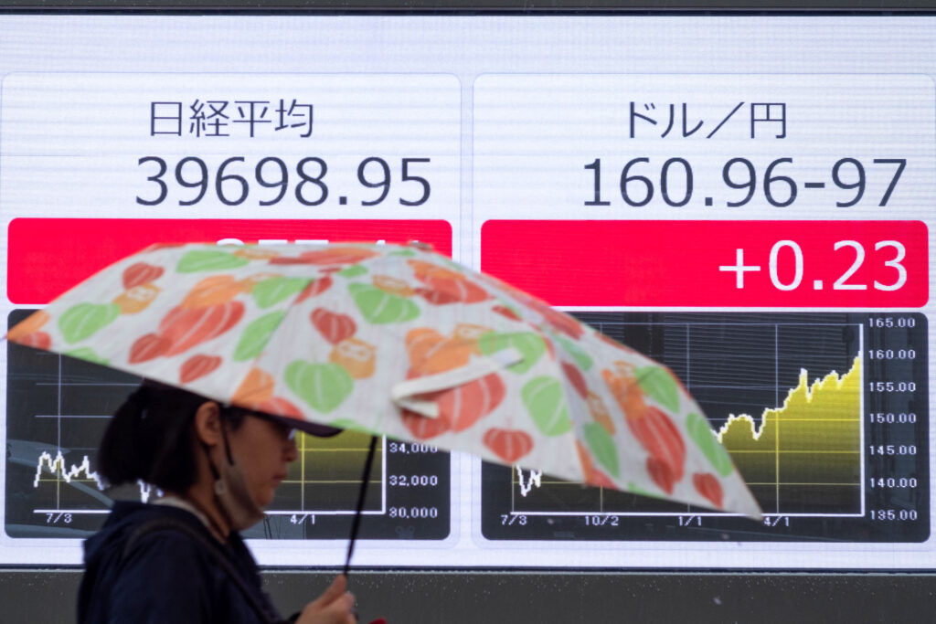 Japan's economy grew at a 0.1% annual pace in the last quarter of the year, just barely avoiding two consecutive quarters of contraction, or a technical recession. (AFP)