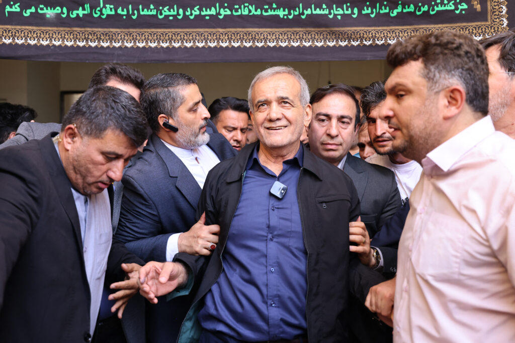 Iranian reformist presidential candidate Masoud Pezeshkian (C) leaves a polling station after voting in Tehran on July 5. (AFP)