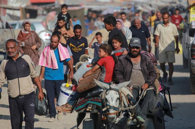 Displaced Palestinians leave western Khan Yunis to areas in the eastern parts of the city following reports of Israeli forces withdrawing from the area in the southern Gaza Strip on July 30, 2024. (AFP)