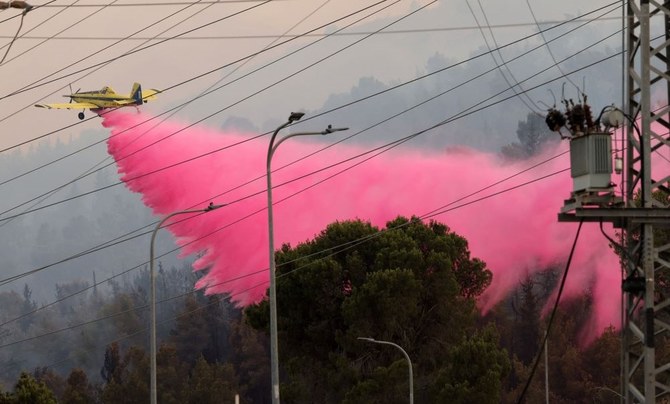 An Israeli firefighter aircraft drops flame retardant after rockets fired from southern Lebanon hit an area in the Upper Galilee region in northern Israel on July 4, 2024. (AFP)