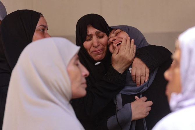 Palestinian women mourn a family member killed in Israeli bombardment, at Al-Maamadani Hospital in Gaza City on July 17, 2024. (AFP)