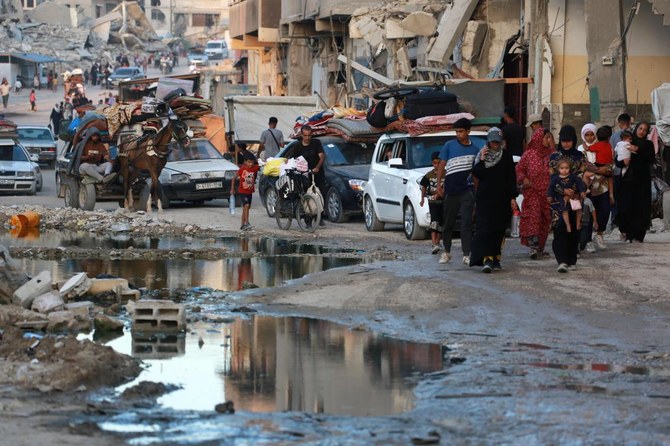 Displaced Palestinians leave an area in east Khan Yunis after the Israeli army issued a new evacuation order for parts of the city and Rafah, in the southern Gaza Strip on July 1, 2024, amid the ongoing conflict between Israel and the Palestinian Hamas militant group. (AFP)