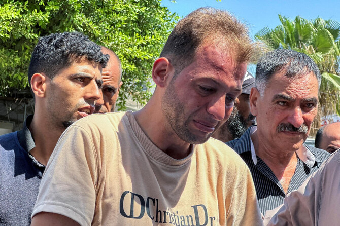 Mohammed Abu Al-Qumsan, whose wife Jumann and newborn twins Asser and Ayssel were killed in an Israeli strike while he was bringing the twins’ birth of certificates, according to medics, reacts at a hospital, in Deir Al-Balah in the central Gaza Strip, Aug. 13, 2024. (Reuters)