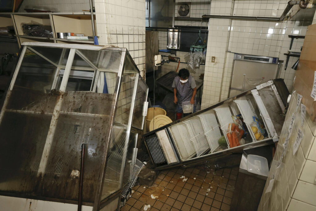 A refrigerator and others fall at a restaurant in Oosaki town, Kagoshima prefecture, southern Japan Friday, Aug. 9, 2024, following Thursday's powerful earthquake. (Kyodo News via AP)