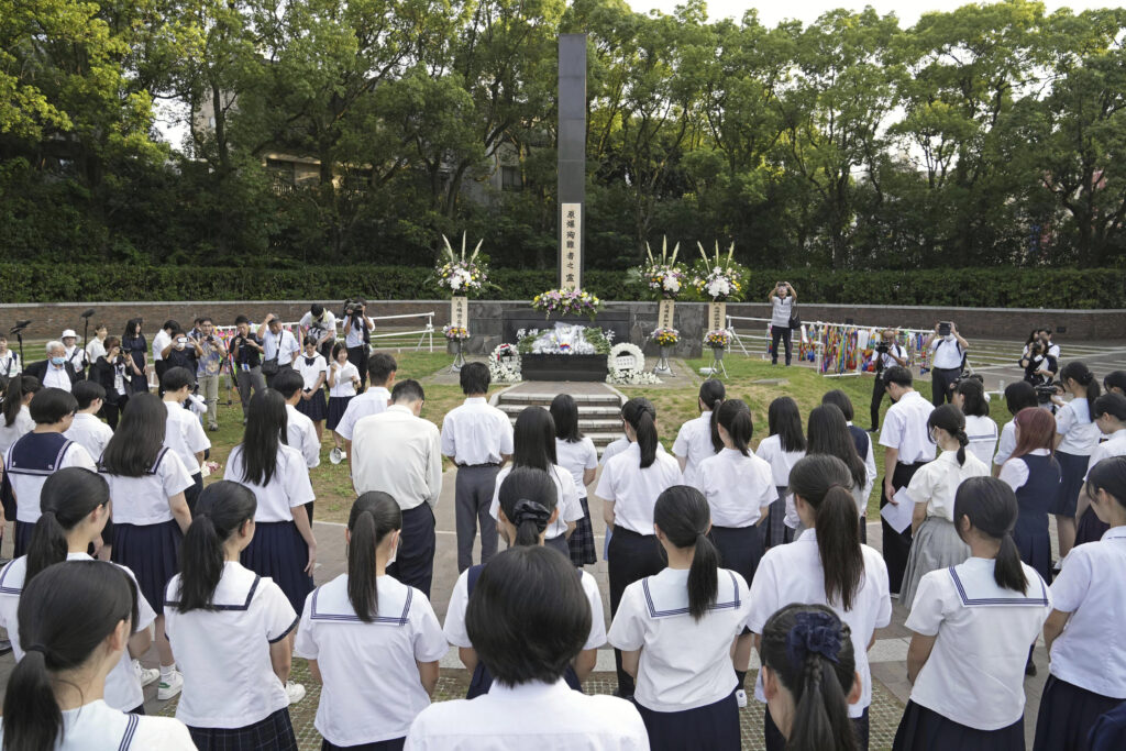 High school students and others offer silent prayers in front of the memorial of the atomic boming hypercenter in Nagasaki, southern Japan on the 79th anniversary of the Nagasaki atomic bombing Friday, Aug. 9, 2024. (Kyodo News via AP)