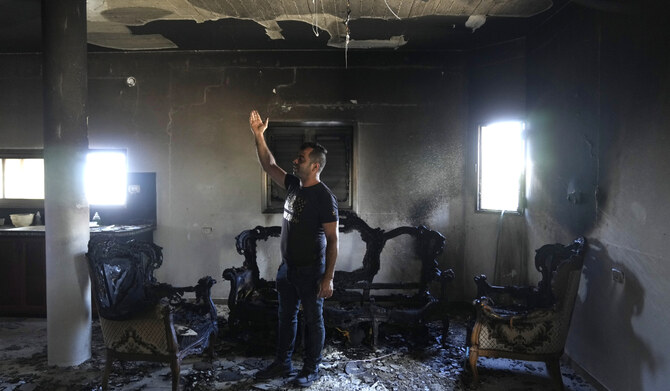 A Palestinian stands in his home the morning after it was torched in a rampage by Israeli settlers in the West Bank village of Jit, Friday, Aug. 16, 2024. (AP)