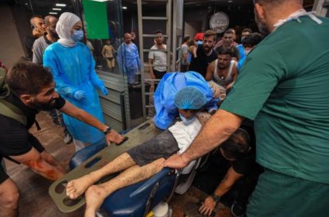 A wounded man in rushed into Bahman hospital after the Israeli military struck a Beirut's southern suburb, on Jul. 30, 2024. (AFP)