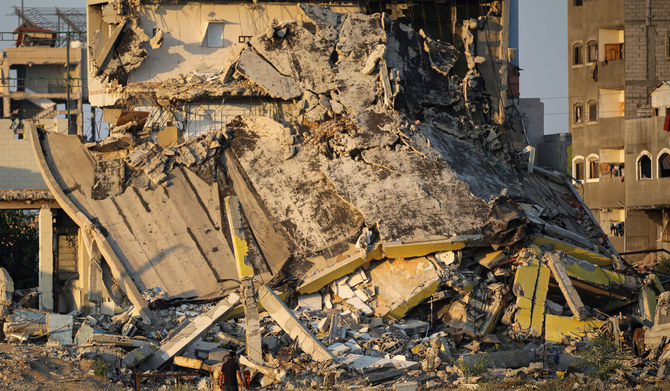 A man walks past the rubble of buildings destroyed during Israeli bombardment, near the al-Maghazi Palestinian refugee camp, in the central Gaza Strip on August 2, 2024, amid the ongoing conflict between Israel and the Palestinian militant group Hamas. (AFP)