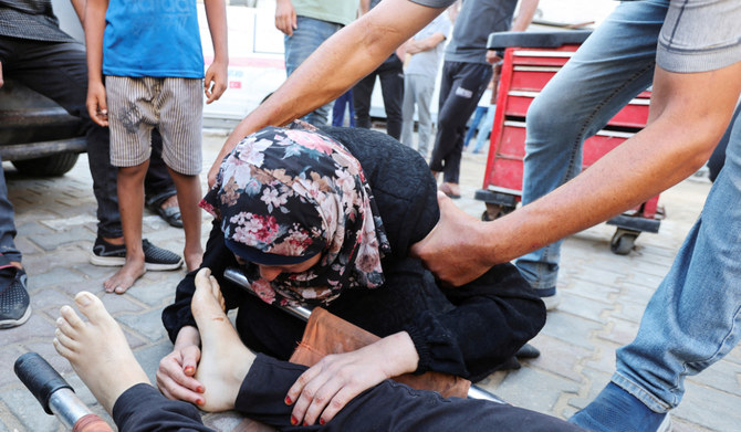 A mourner reacts next to the body of Palestinian Ismail Nofal, who was killed in an Israeli strike on a tent camp for displaced people, amid the Israel-Hamas conflict, at Al Aqsa Martyrs hospital in Deir Al-Balah in the central Gaza Strip, August 4, 2024. (REUTERS)
