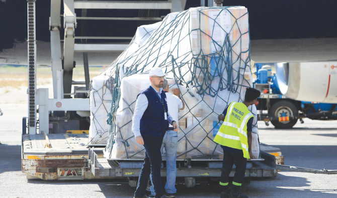 Workers unload crucial medical supplies delivered by the World Health Organization at Beirut-Rafic Hariri International Airport on Monday. (AFP)