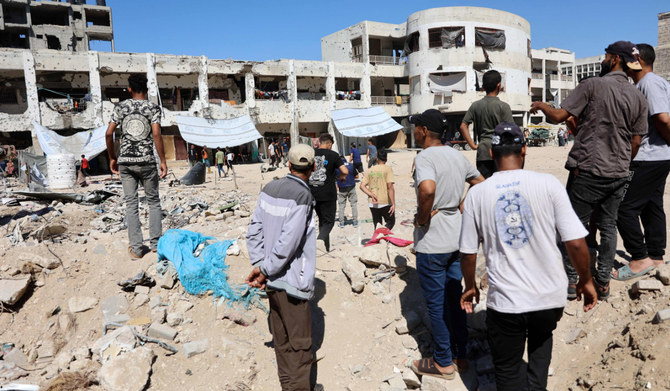 Palestinians check the damage in the al-Zahra school used as a refuge by displaced Palestinians following an Israeli strike, in the Shujaiya neighbourhood of Gaza City on August 8, 2024, amid the ongoing conflict between Israel and the militant group Hamas. (AFP)