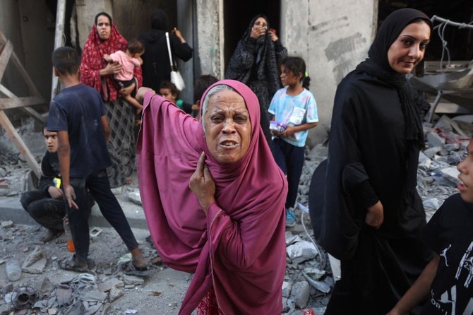 A woman reacts as people inspect the damage following Israeli bombardment in Gaza City’s Sheikh Radwan neighborhood on August 11, 2024, amid the ongoing conflict between Israel and the Palestinian militant group Hamas. (AFP)