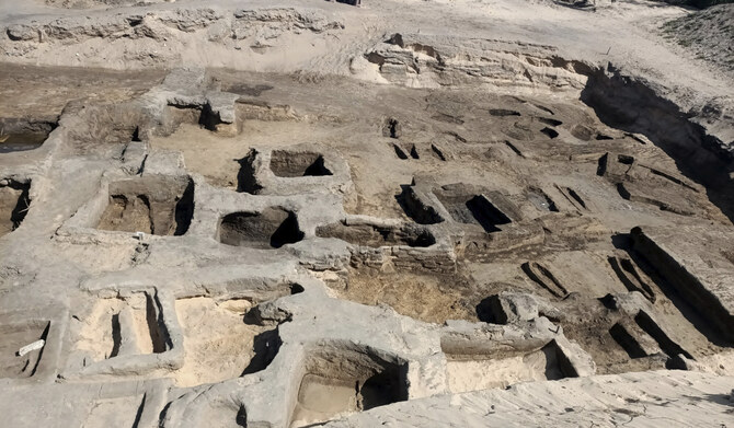 In this image provided by Egypt's Supreme Council of Antiquities, archeologists observe the site where they discovered 63 mud-brick tombs at the Tell al-Deir necropolis, in the Nile Delta town of Damietta, about 125 miles (200 km) north of Cairo, Egypt. (AP)
