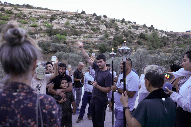 Activists try to reach a land confiscated by Israeli settlers in the al-Makhrur area near Beit Jala in the Israeli-occupied West Bank on August 15, 2024. (AFP)