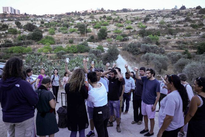 Activists try to reach a land confiscated by Israeli settlers in the al-Makhrur area near Beit Jala in the Israeli-occupied West Bank on August 15, 2024. (AFP)