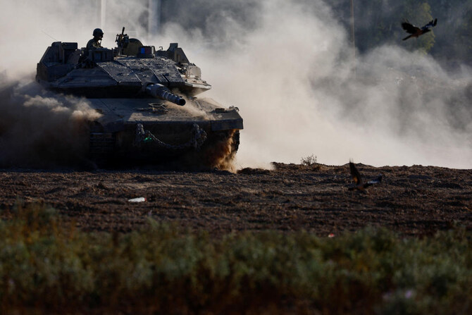 An Israeli tank manouvers near the Israel-Gaza border, amid the ongoing conflict between Israel and Hamas, in Israel. (Reuters)