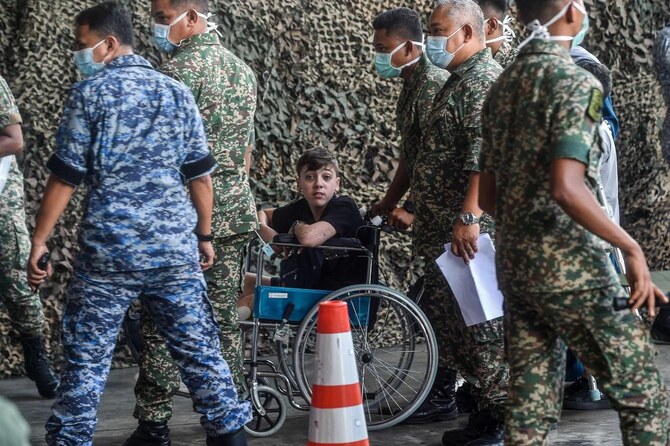 A Palestinian child injured in Gaza arrives in Malaysia after being flown from Egypt to receive medical treatment, at the Malaysian Air Force base in Subang, amid the ongoing war between Israel and the Palestinian Hamas movement in the Gaza Strip. (AFP)