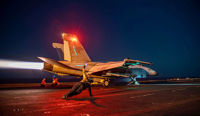 In this on February 24, 2024, image released by the US Central Command, a US fighter plane launches from the deck of the aircraft carrier USS Eisenhower in the Red Sea during operations against Houthi targets. (AFP)