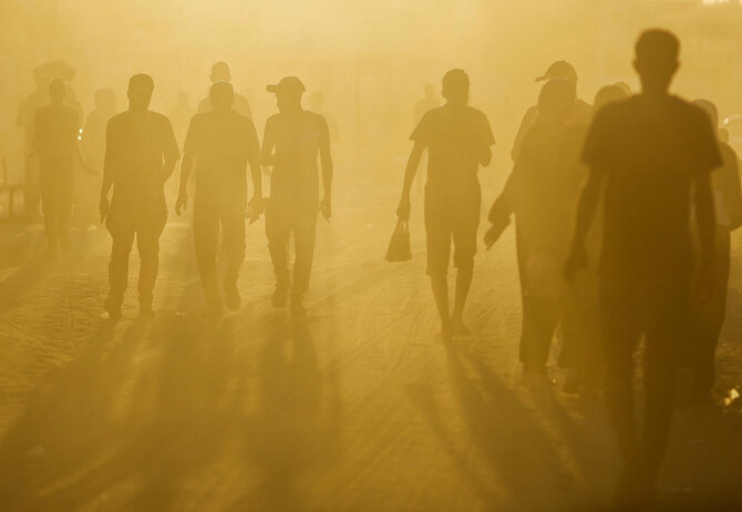 Palestinians walk in an area damaged during the Israeli offensive, amid the ongoing conflict between Israel and Hamas, in Khan Younis, in the southern Gaza Strip, Aug. 20, 2024. (Reuters)
