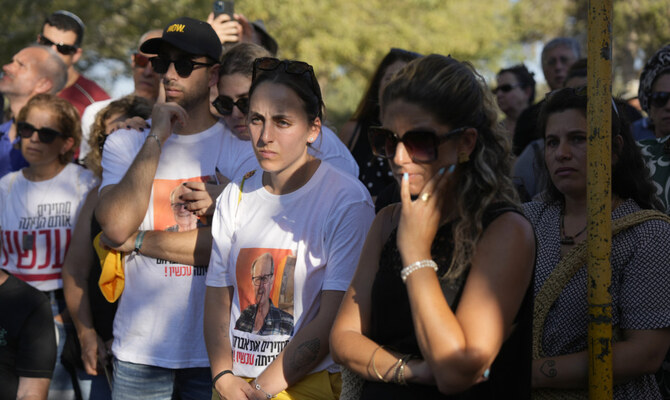 Mourners attend the funeral for slain hostage Avraham Munder, who was killed in Hamas captivity in the Gaza Strip, at Kibbutz Nir Oz, southern Israel, Wednesday, Aug. 21, 2024. His son, Roee, who was killed on Oct. 7, 2023, was reburied at the Kibbutz. On Tuesday, the Israeli military said its forces recovered six bodies of hostages kidnapped on Oct. 7 in an overnight operation in southern Gaza. (AP)