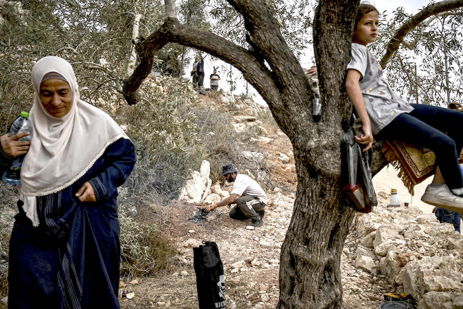Last September, settlers from Shaarei Tikva used wastewater to poison Palestinian olive groves and crops east of Qalqilya. Above, a Palestinian family during the olive harvest at a grove outside Ramallah in the occupied West Bank. (AFP file photo)