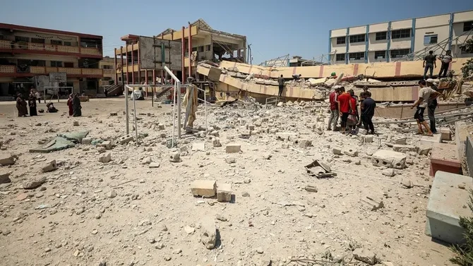Palestinians inspect a school sheltering displaced people after it was hit by an Israeli strike, amid the Israel-Hamas conflict, in Gaza City, on August 20, 2024. (Reuters)