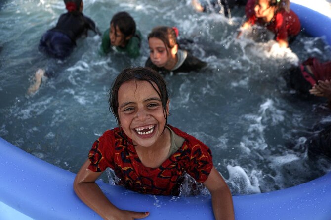 The pools at the camp for displaced people provided rare entertainment to young boys and girls whose lives have been scarred by war and poverty. (AFP)