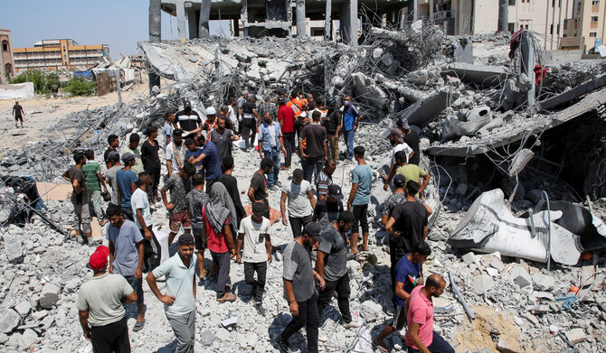Palestinians inspect damage in Qatari-funded Hamad City, following an Israeli raid, amid the ongoing conflict between Israel and Hamas, in Khan Younis, in the southern Gaza Strip, August 24, 2024. (REUTERS)