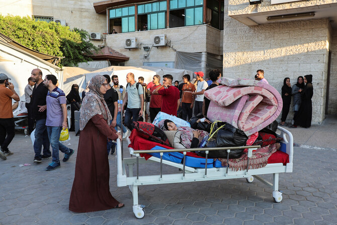 Patients fearing an Israeli ground operation are assisted to flee Al-Aqsa Martyrs hospital, after Israeli army ordered the evacuation of nearby areas in Deir Al-Balah, central Gaza Strip, August 25, 2024. (Reuters)
