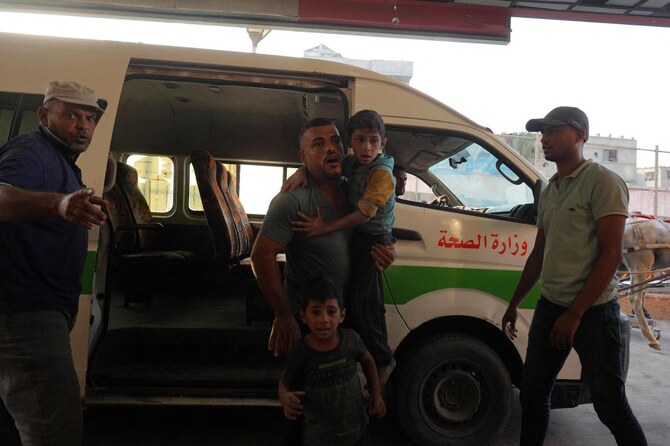 A man arrives with wounded children to the Nasser hospital following Israeli bombardment on Khan Yunis in the southern Gaza Strip on August 27, 2024, amid the ongoing conflict between Israel and the militant Hamas group. (AFP)