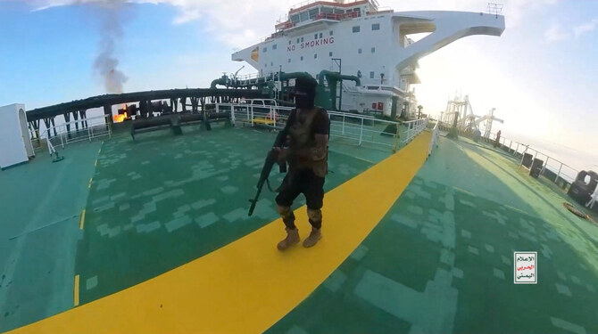 A Yemen Houthi militant walks on the deck of the Sounion oil tanker on the Red Sea, in this screen grab picture released on August 29, 2024. (Houthi Military Media/Handout via REUTERS)