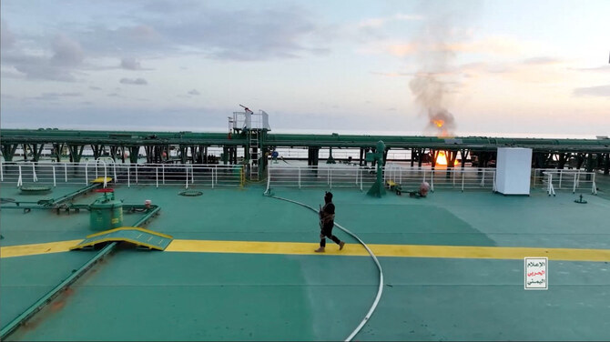 A Yemen Houthi militant walks on the deck of the Sounion oil tanker on the Red Sea, in this screen grab picture released on August 29, 2024. (Houthi Military Media/Handout via REUTERS)