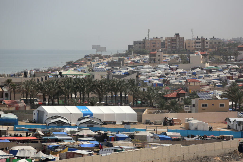 A World Food program (WFP) facility stands amid tents housing internally displaced Palestinians, along the coastline in Deir el-Balah in the central Gaza Strip on May 10, 2024. (AFP)